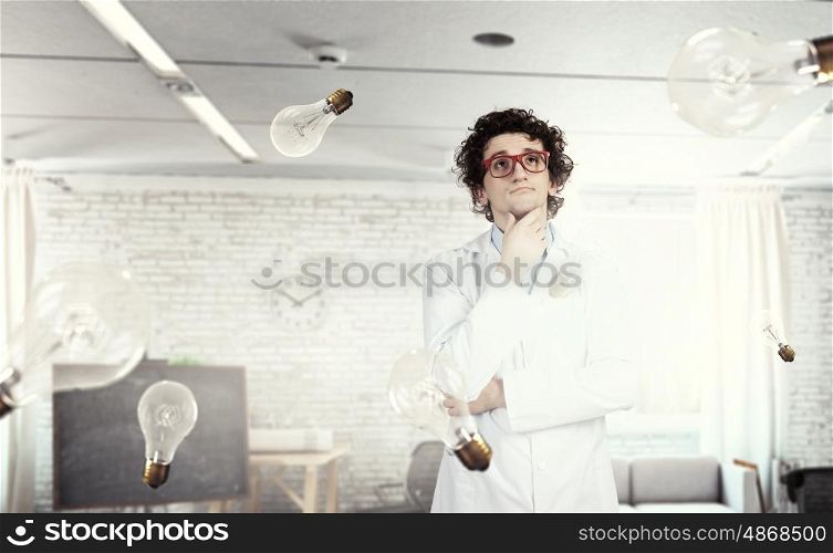 Thoughtful male doctor. Young doctor in glasses thinking something over