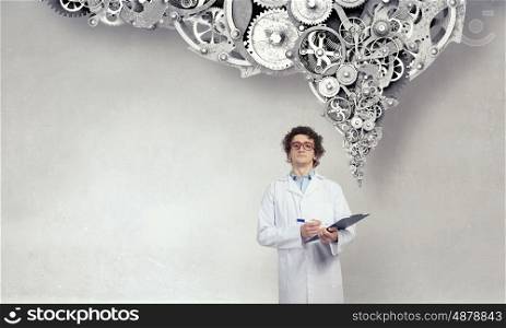 Thoughtful male doctor. Young doctor in glasses thinking something over
