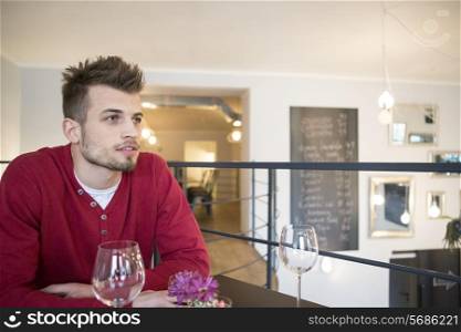 Thoughtful man looking away in cafe