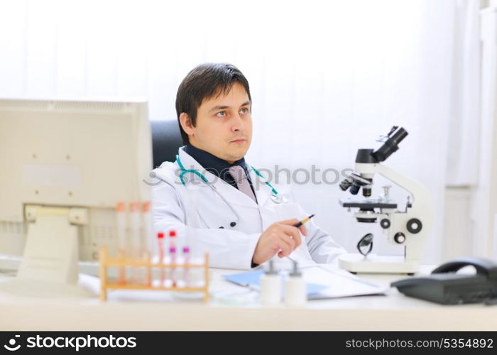 Thoughtful medical doctor at office