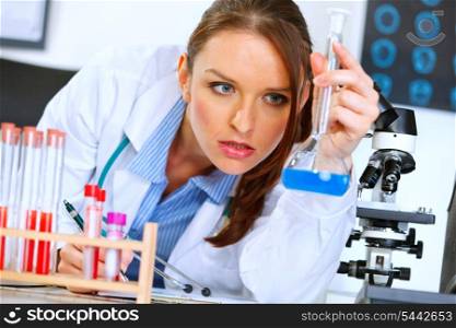 Thoughtful medical doctor woman in laboratory analyzing results of medical test&#xA;
