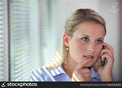 Thoughtful office worker mid phone call