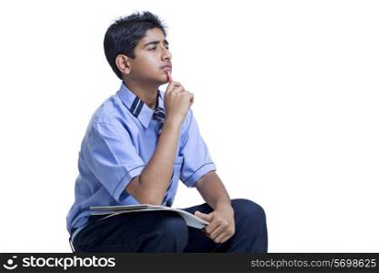 Thoughtful student studying over white background