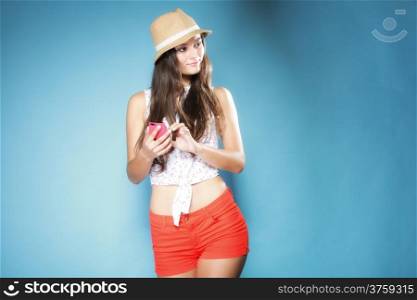 Thoughtful summer girl with smartphone mobile phone on blue