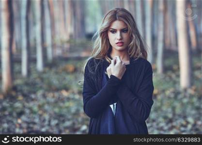 Thoughtful woman alone in a poplar forest. Girl worried outdoors