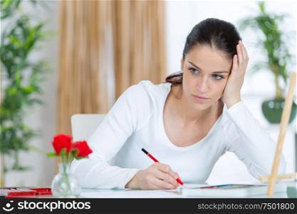thoughtful woman while drawing
