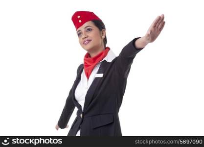 Thoughtful young air hostess with arms outstretched isolated over white background
