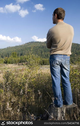 thoughtful young man look at the mountains