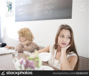 Thoughtful young woman having coffee in cafe