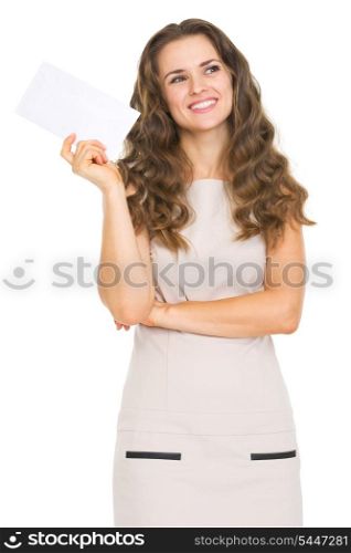 Thoughtful young woman holding letter