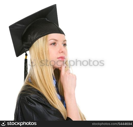 Thoughtful young woman in graduation gown looking on copy space