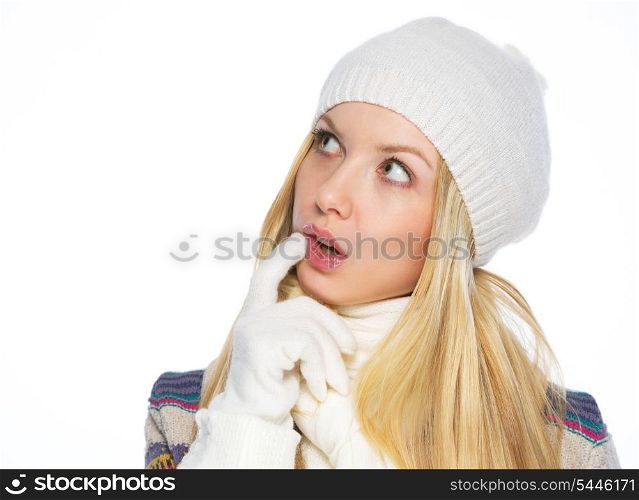 Thoughtful young woman in winter clothes looking on copy space