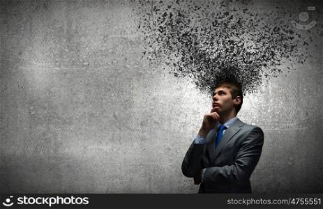 Thoughts in head. Young thoughtful businessman and thoughts above his head