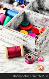 Thread and buttons with beads sewing and needlework. Buttons and spool of thread
