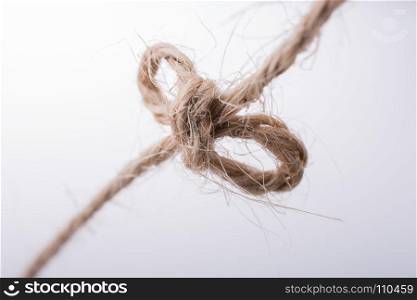 Thread tied as knot on a light color background