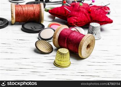 Threads for sewing,pincushion and set of buttons from clothing