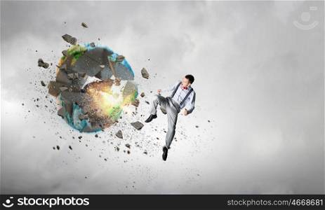 Threat of ecological catastrophe. Man in anger crashing earth planet. Elements of this image are furnished by NASA