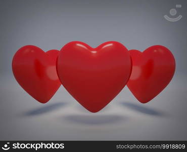 Three 3d hearts on grey background