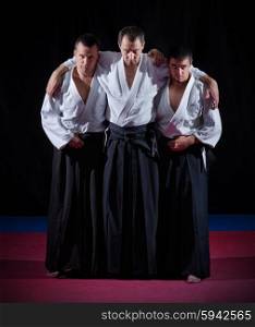 Three aikido fighters on black
