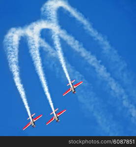 three airplanes Extra EA-300 on airshow