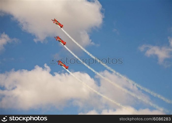 three airplanes in formation on airshow