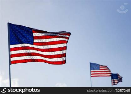 Three American flags fluttering in the sky