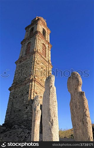 Three ancient Menhirs and church at Pieve in the Nebbiu region of Corsica