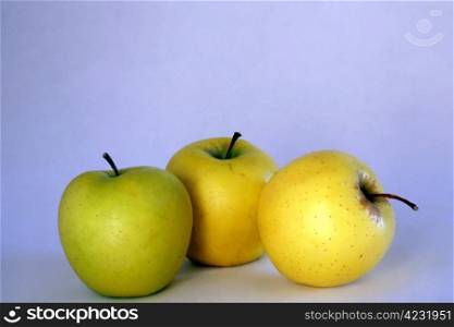 Three apples isolated on blue background