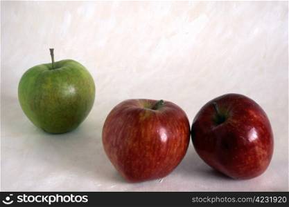 Three apples on painted background