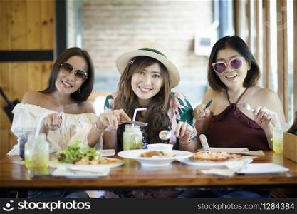 three asian woman ready to eating western food on table