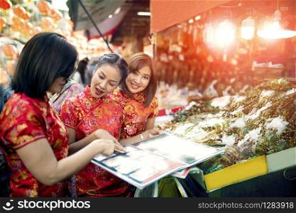 three asian woman wearing chinese tradition clothes happiness touring in yaowarat road one most popular traveling and famous street food in bangkok thailand