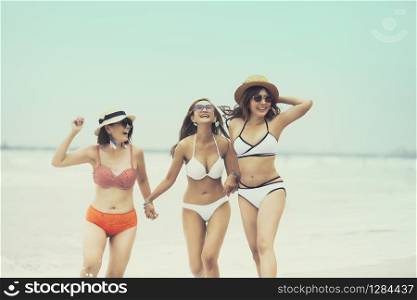 three asian woman with beach bikini happiness on beach