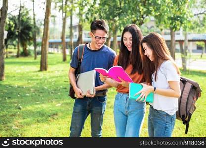Three Asian young campus students enjoy tutoring and reading books together. Friendship and Education concept. Campus school and university theme. Happiness and funny of learning in college