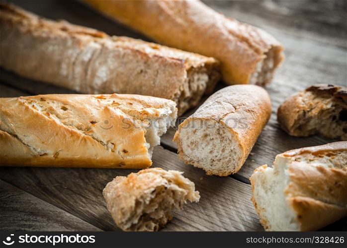 Three baguettes on the wooden background