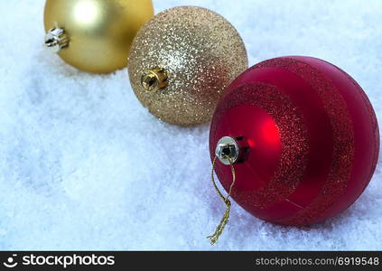 Three balls in the snow. Cold shade of the image