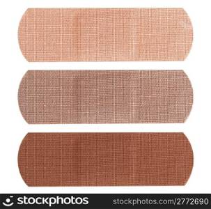 Three bandages in different skin colors isolated on white background.
