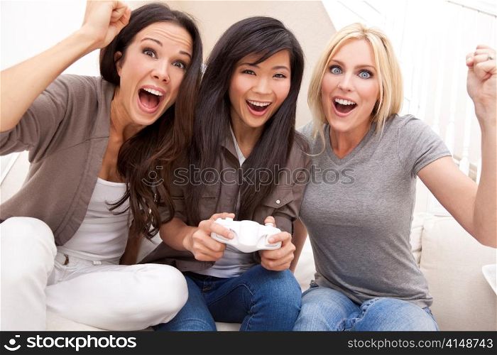 Three Beautiful Women Friends Playing Video Games at Home