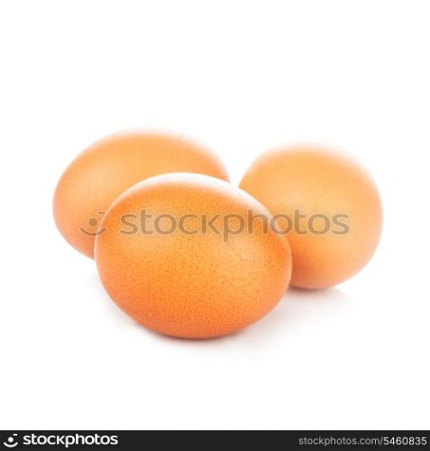 Three beige chicken eggs isolated on white