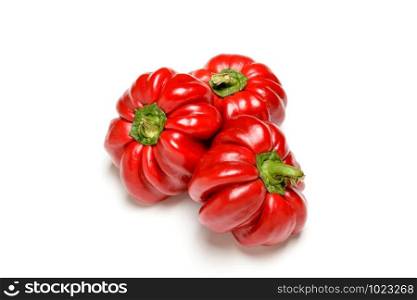 Three bell peppers from the kitchen garden, isolated on white background
