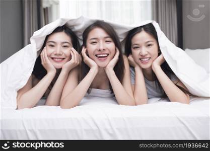 Three best friends lying on the bed