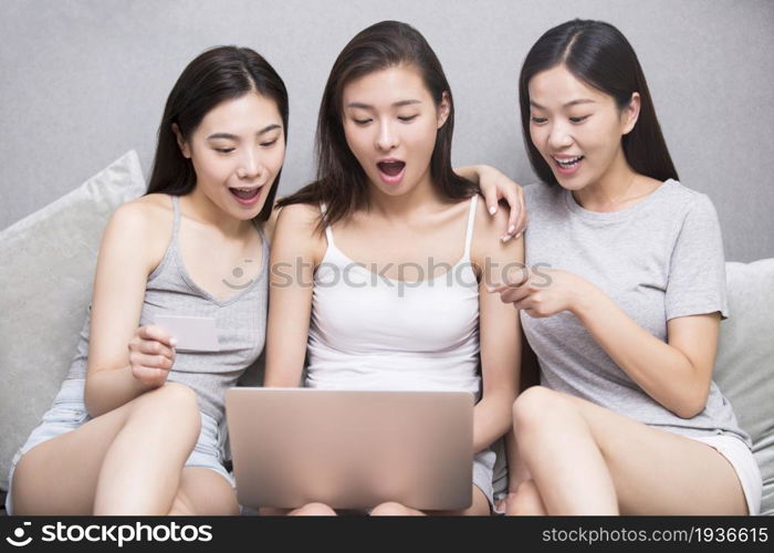 Three best friends using a computer together