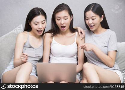 Three best friends using a computer together