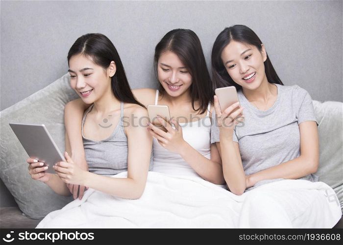 Three best friends using a mobile phone together