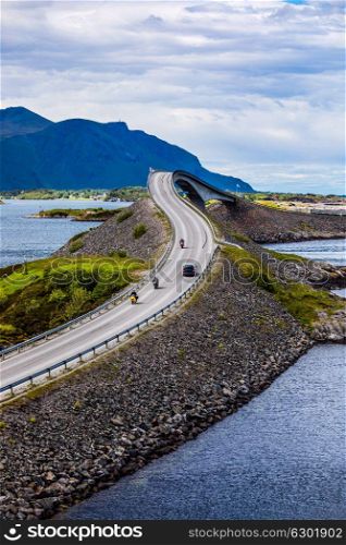 "Three bikers on motorcycles. Atlantic Ocean Road or the Atlantic Road (Atlanterhavsveien) been awarded the title as "Norwegian Construction of the Century"."