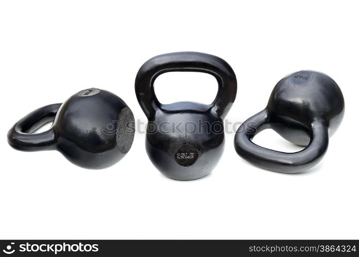 three black shiny 35 lb iron kettlebells for weightlifting and fitness training isolated on white with clipping paths