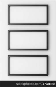 three blank black photo frames on white wall. 3d illustration