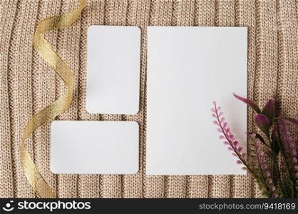 Three blank card, gold ribbin and a leaf on a sweater