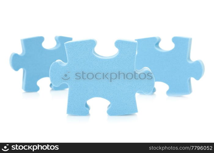 three blue puzzle pieces over a white background