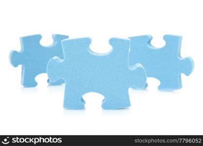 three blue puzzle pieces over a white background