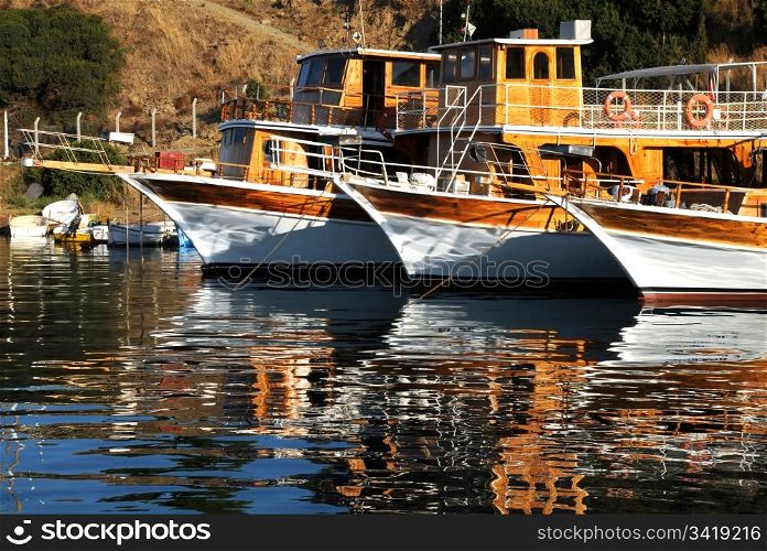 Three boats moored in the harbor in Turkey.